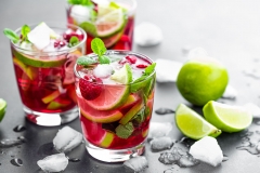 Raspberry mojito cocktail with lime, mint and ice, cold, iced refreshing drink or beverage