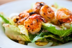 Grilled shrimps and fresh green salad served for lunch