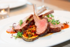 Grilled rack of lamb with vegetables on plate