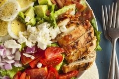 Healthy Hearty Cobb Salad with Chicken Bacon Tomato Onions and Eggs